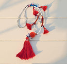 XXL Kette im Boho-Stil mit neon Orange | beige Perlen | Pompons Kaurimuscheln | Quasten | Ibiza Style